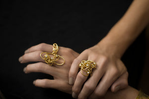 18 karat gold and diamond cocktail rings rings on model's hands, making a bold statement. 
